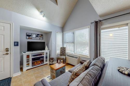 a living room with a couch and a tv at Condo 110 at North Creek Resort in Blue Mountains