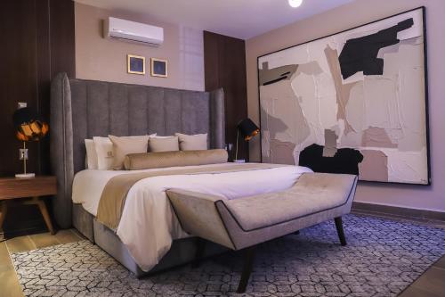 a bedroom with a large bed and a painting on the wall at Hotel Boutique Corazón Mexicano in Guanajuato