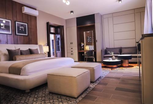 a bedroom with a large bed and a living room at Hotel Boutique Corazón Mexicano in Guanajuato
