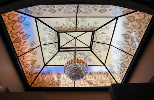 a chandelier hanging from a ceiling in a room at Hotel Boutique Corazón Mexicano in Guanajuato
