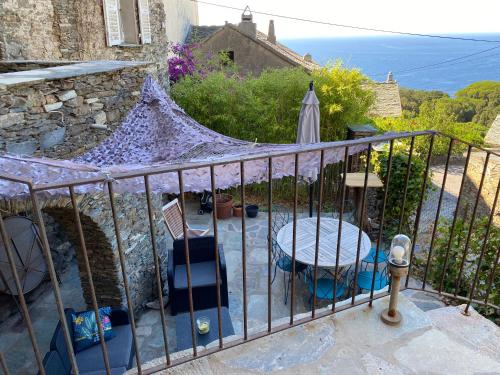 a patio with a table and chairs on a balcony at Torra di Ciocce in Pino