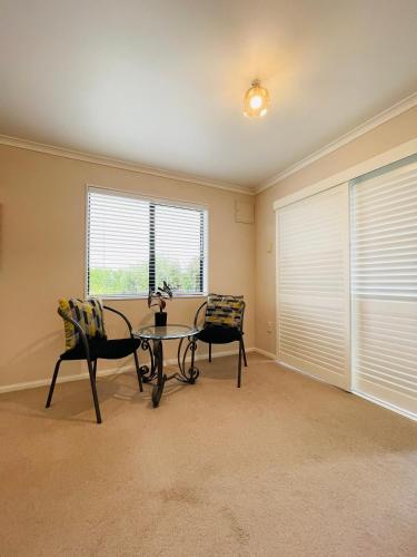 a dining room with a table and two chairs at Habour View - Tauranga Central in Tauranga