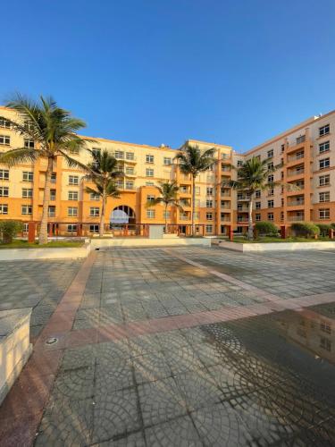 an empty parking lot in front of a large building at relax room in King Abdullah Economic City