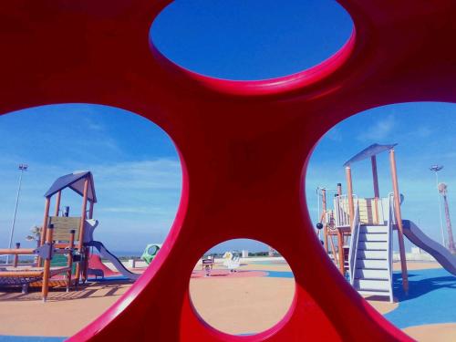 a view of a playground with a red slide at Four Seasons Apartment in Agadir