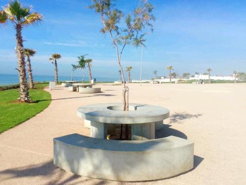 a park with a table with a tree in it at Four Seasons Apartment in Agadir
