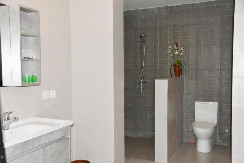 a bathroom with a shower with a toilet and a sink at 2 Bedroom Villa with Pool & Close to Setangi Beach in Mangsit