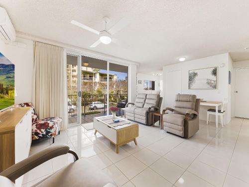 a living room with a couch and chairs and a table at Nelson Point Unit 2 Golden Beach QLD in Golden Beach