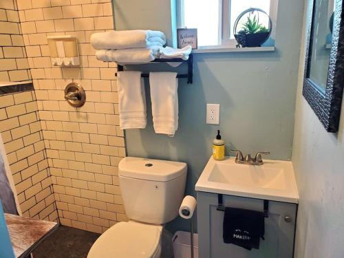 a bathroom with a toilet and a sink and towels at TCR @ 290 Wine Trail #11 - New 40' unit sleeps 4! in Hye