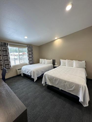 a hotel room with two beds and a window at Black Jack Inn in South Lake Tahoe