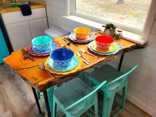 a table with plates and bowls on top of it at TCR at 290 Wine Trail #13 Now dog friendly in Hye