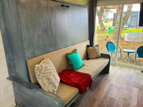 a couch with pillows on it in a porch at TCR at 290 Wine Trail #13 Now dog friendly in Hye