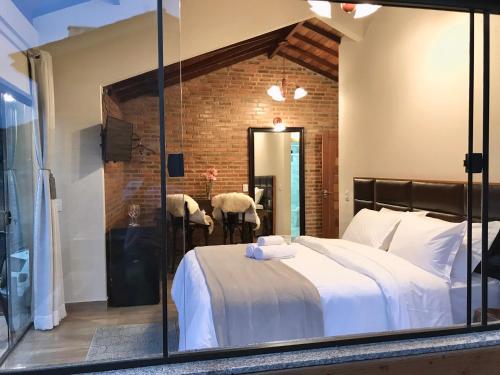 a bedroom with a white bed and a mirror at Valle Piemonte in Divisa