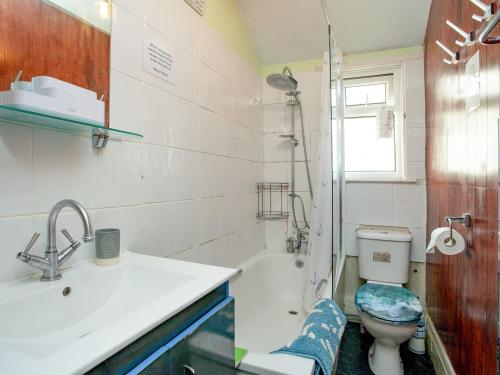 a bathroom with a sink and a toilet and a shower at Devon Beach Station in Paignton