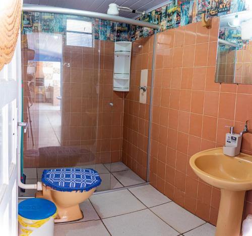 uma casa de banho com um WC, um chuveiro e um lavatório. em Casa c ótima localização piscina e WiFi, Cuiabá em Cuiabá