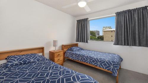 A bed or beds in a room at Windbourne unit 4 Golden Beach QLD