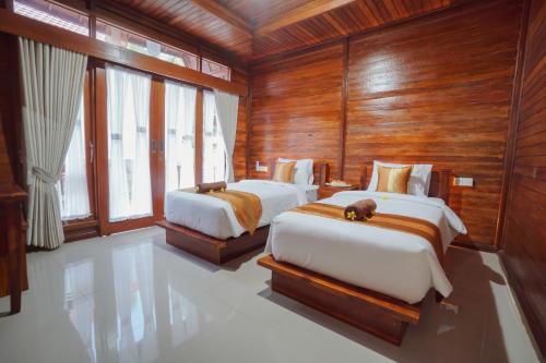 מיטה או מיטות בחדר ב-Kawi Penida Room