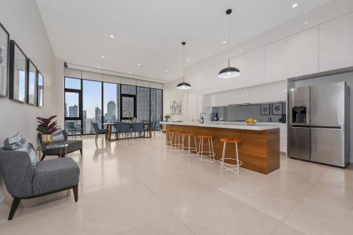 an open kitchen and living room in a house at Melbourne City Apartments Panoramic Sky View Penthouse in Melbourne
