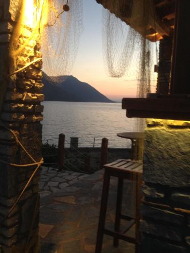 a view of the ocean from a bar with a view at Thesmos Village in Mýtikas