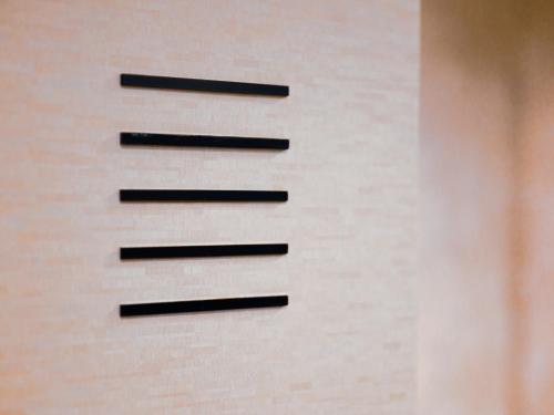 a brick wall with black lines on it at GLAMROSE -Adult Only Motel- in Gotemba