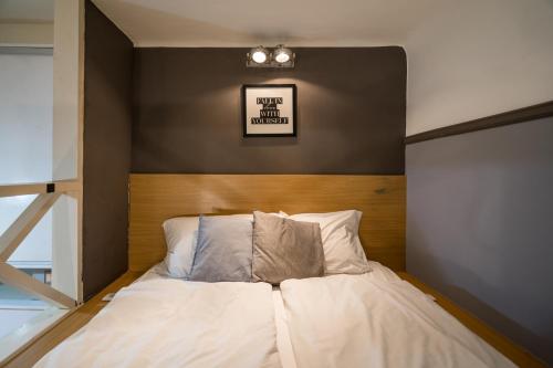 a bed with white sheets and pillows in a room at Z44- Boutique Apartment, Best Location. By BQA in Budapest