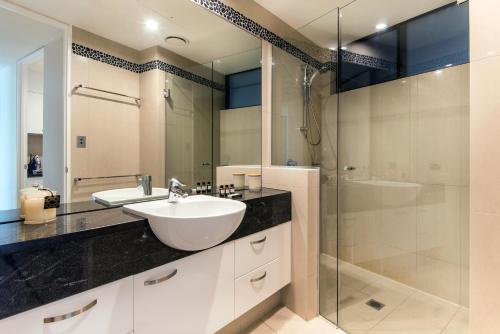 a bathroom with a sink and a shower at Edge Apartments on Hamilton Island by HIHA in Hamilton Island