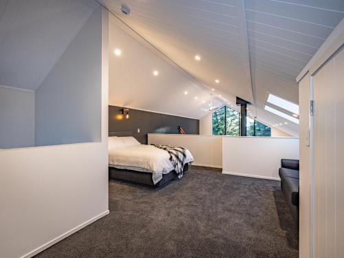 a bedroom with a bed and a couch at Mangawhero River Chalet in Ohakune