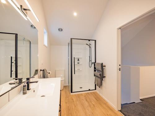 a bathroom with two sinks and a shower at Mangawhero River Chalet in Ohakune