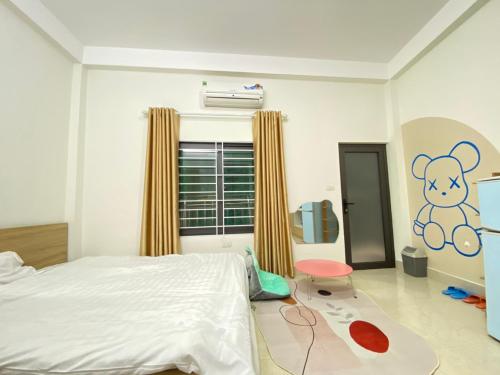a bedroom with a bed and a teddy bear on the wall at Easystay Apartment - 154 Đinh Thôn, Mỹ Đình, Hà Nội in Hanoi