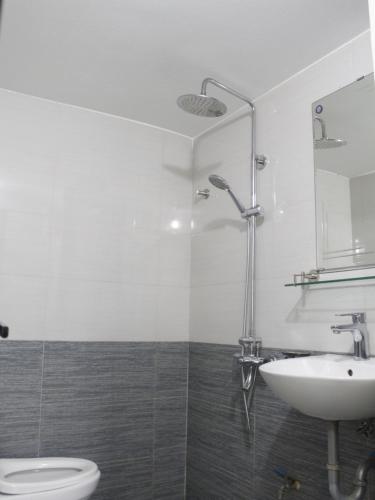 a white bathroom with a sink and a toilet at Easystay Apartment - 154 Đinh Thôn, Mỹ Đình, Hà Nội in Hanoi