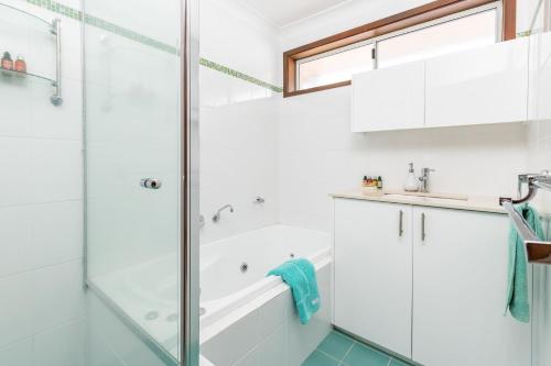 a bathroom with a shower and a sink at Waterfront Haven with your own private jetty in Forster
