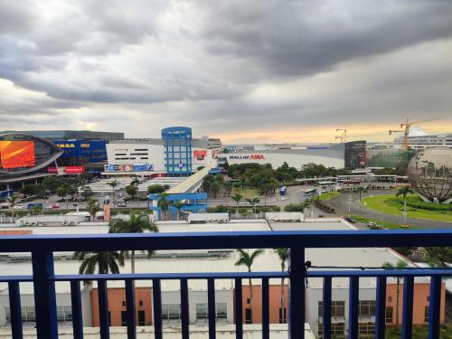 a view of a city from a balcony at Sea Residences MOA Complex - Ruffa's Condotel in Manila