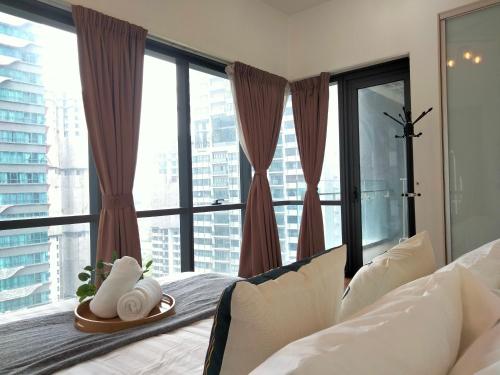 a bedroom with a bed with a large window at Element Signature Suites 5pax 3Br Ampang KLCC in Kuala Lumpur