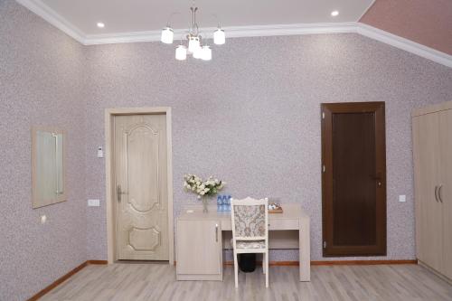 a room with a table with a vase of flowers on it at RamRamay in Qax