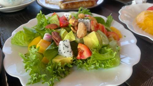 a salad on a white plate on a table at Touch Glamping Koh Yao Noi ทัช แกรมปิ้ง เกาะยาวน้อย in Ko Yao Noi
