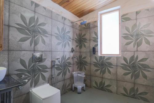 a bathroom with a plant mural on the wall at Seclude Pangot, Perch in Nainital