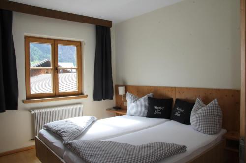 a bedroom with a bed and a window at Gasthof zum Stern in Oetz
