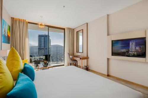 a bedroom with a large bed and a large window at PANORAMA Condotel by HLG in Nha Trang