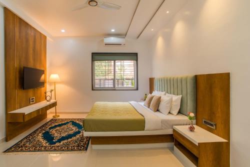 a hotel room with a bed and a window at Idyll Hills by VEO - Part of StayVista in Panchgani