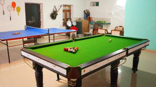 a pool table with balls on it in a room at Wow Relish in Alwar