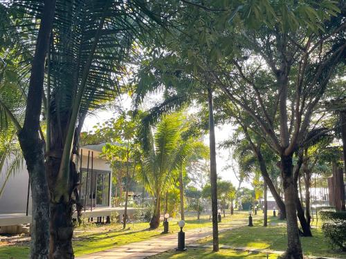 a park with palm trees in front of a building at Cede Boutique Beach Resort in Ko Phayam