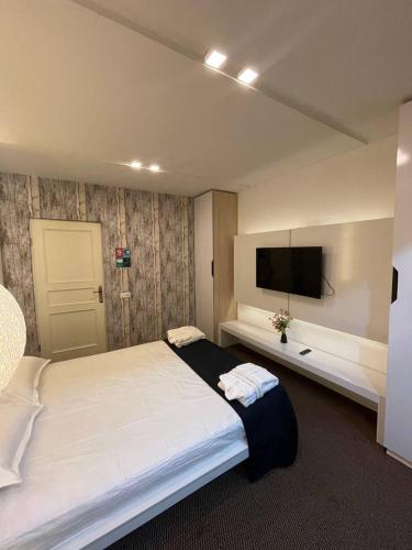 a bedroom with a large bed and a flat screen tv at iO Boutique Hotel Bishkek in Bishkek