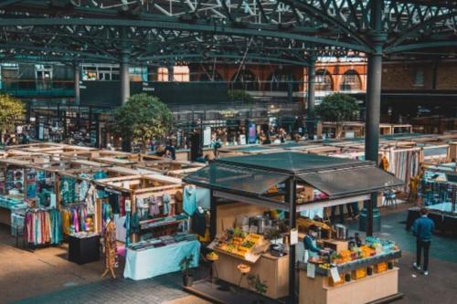 a market with a bunch of fruits and vegetables at Barbican Pad in London