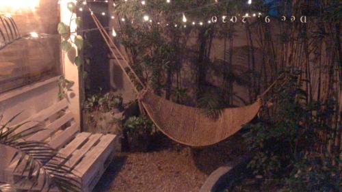 a hammock hanging from a fence in a garden at Boho Inspired Home Near Rockwell in Manila