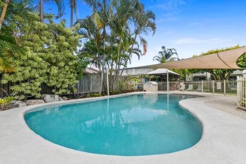 a swimming pool in a yard with trees at Terrapin Apartment 4 in Noosaville