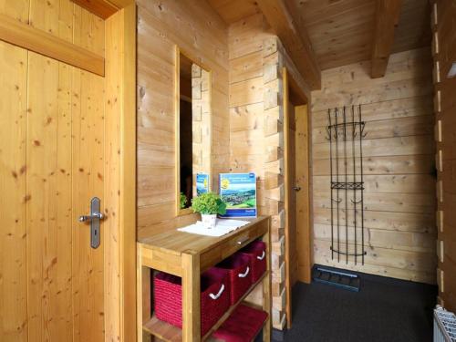 a small wooden room with a wooden counter in a cabin at Ferienwohnungen Berger in Scheidegg