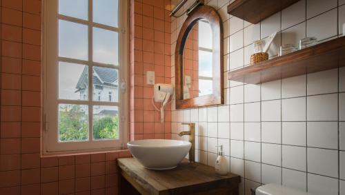 a bathroom with a bowl sink and a window at Le Soleil Boutique Hotel in Da Lat