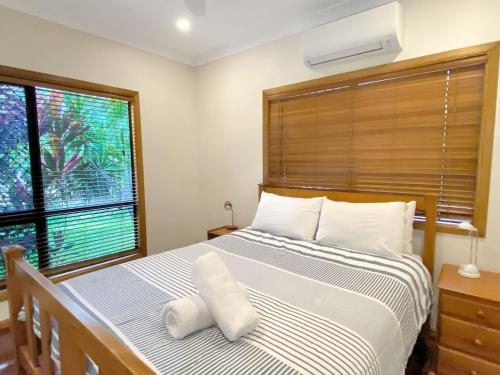 a bedroom with a large bed and a window at Mills Cottage in Arcadia