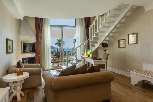 a living room with a couch and a staircase at Sianji Well-Being Resort in Turgutreis