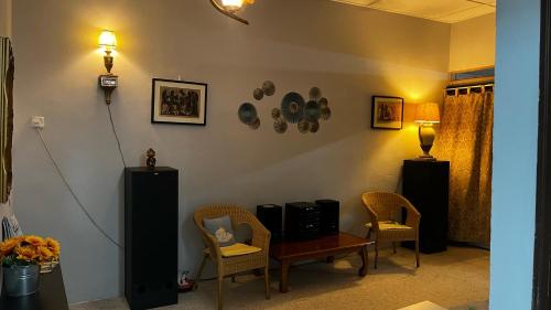 a living room with a table and chairs at Angel Spa Garden's Homestay in Ipoh