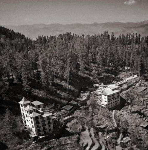 a black and white photo of buildings on a mountain at Tethys Himalaya Narkanda in Nārkanda